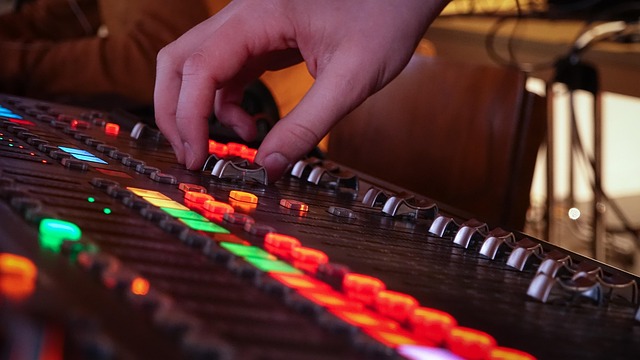 studio desk with microphone audio interface and notebook neon accent lighting