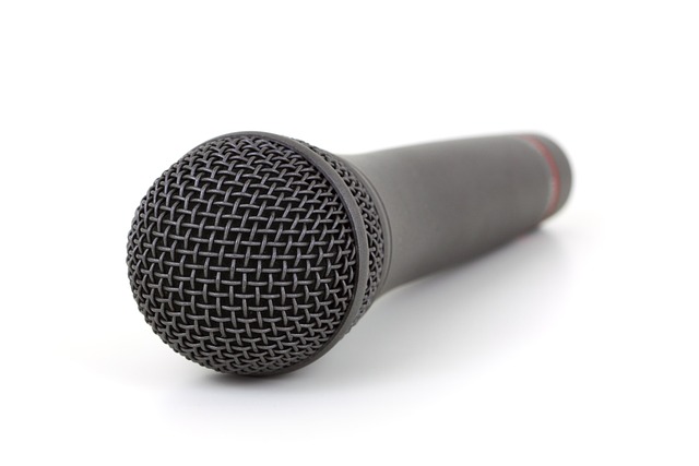 close-up studio microphone pop filter and headphones cinematic lighting
